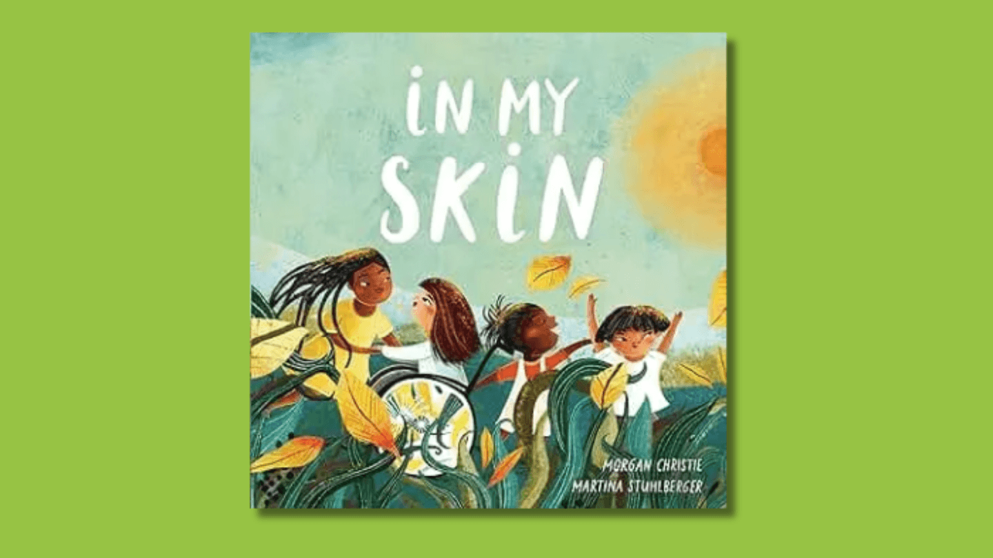 The cover of In My Skin shows an illustration of a racially diverse group of children dancing outside under the sun. One of the children uses a wheelchair. 