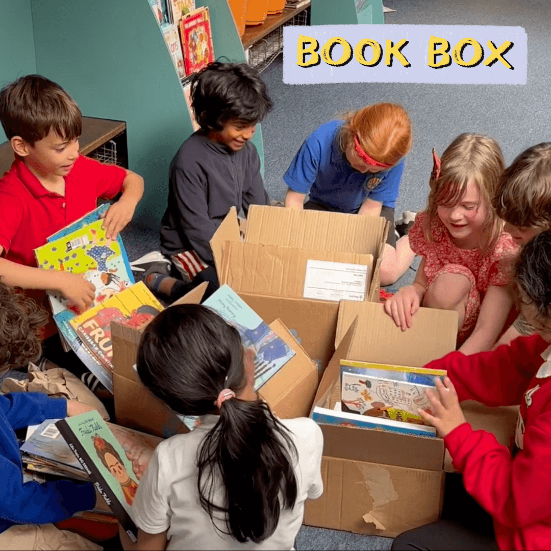 Schoolchildren opening boxes of books