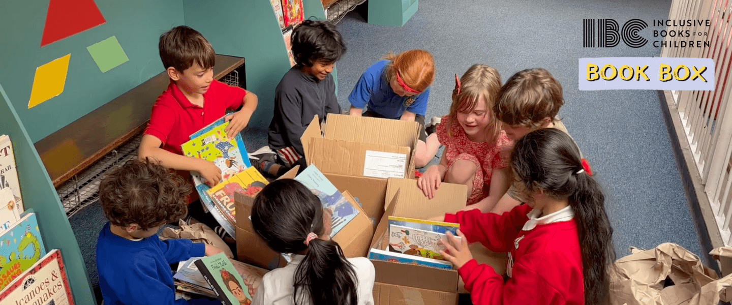 School children opening boxes of books