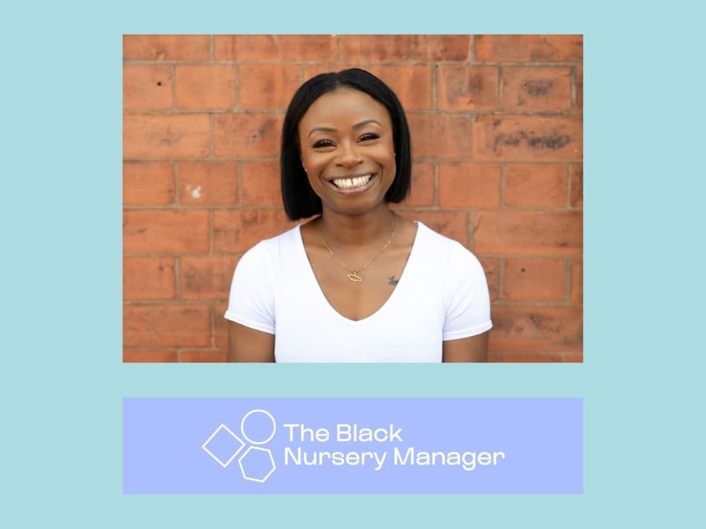 Image of young Black woman with short, bobbed black hair, wearing and T-shirt and standing against a brick wall. 